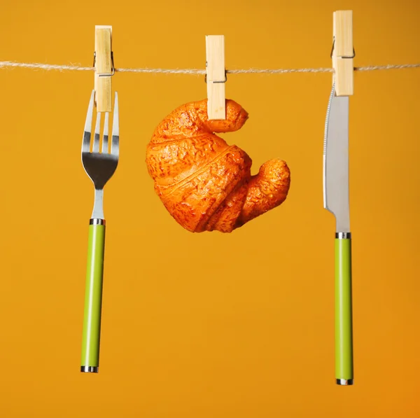 Fork, knife and croissant — Stock Photo, Image