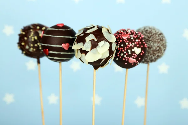 Tasty cake pops on blue background — Stock Photo, Image