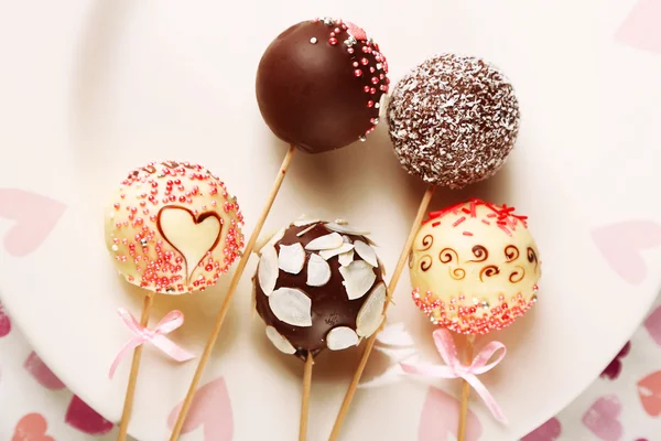 Tasty cake pops on plate, close up — Stock Photo, Image