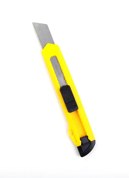 Yellow stationery knife isolated on white — Stock Photo, Image