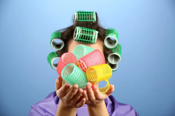 Girl in hair curlers on colorful background — Stock Photo, Image