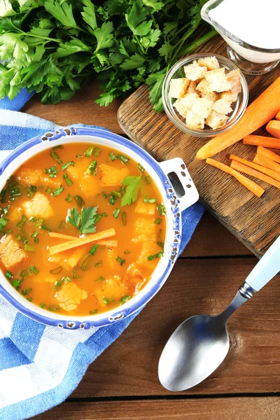 Composition with carrot soup, ingredients and herbs on color wooden background — Stock Photo, Image