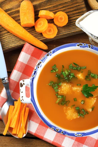 Carrot soup  in bowl, on wooden background — Stock Photo, Image