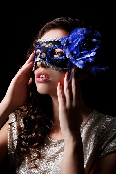 Beautiful girl with masquerade mask on dark background Stock Picture