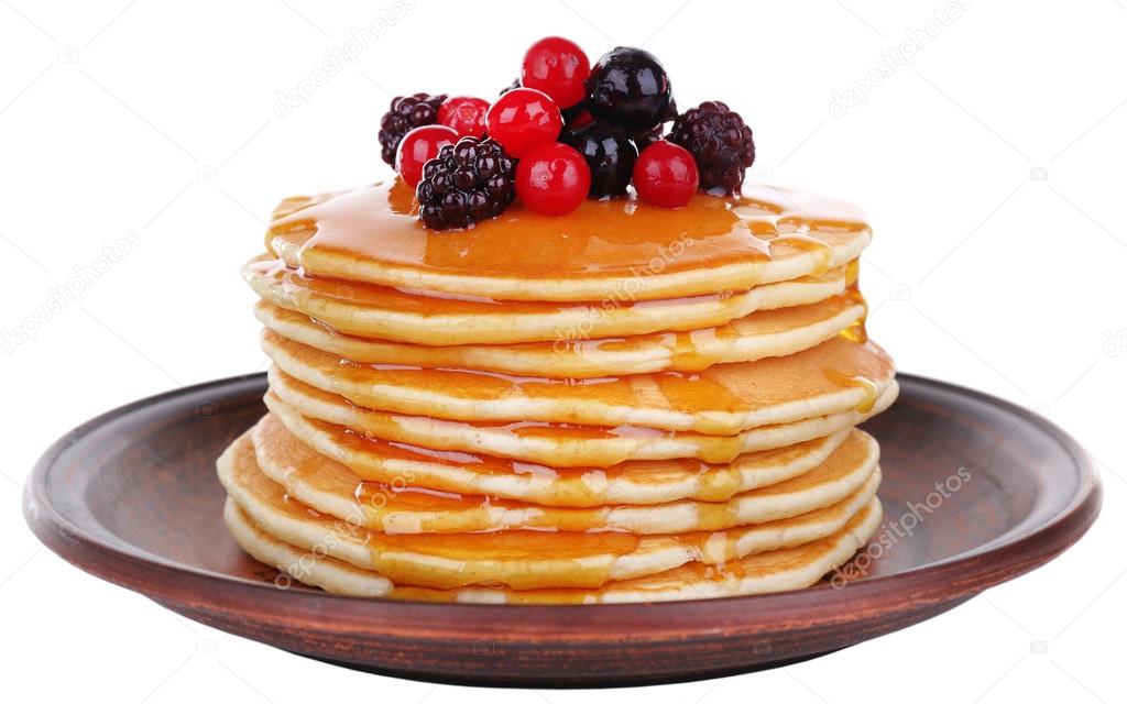 Stack of delicious pancakes with berries and honey isolated on white