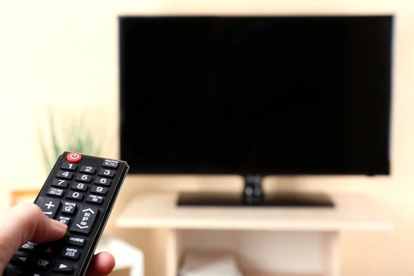 Watching TV with  remote controller — Stock Photo, Image