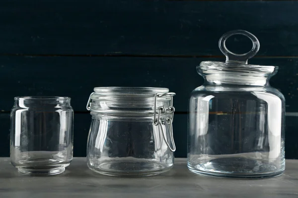 Glassware on dark color wooden background — Stock Photo, Image