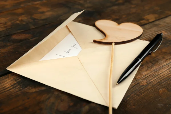 Envelope with heart and pen — Stock Photo, Image