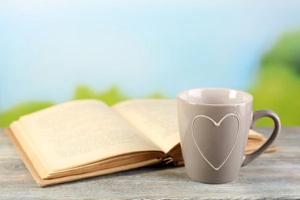 Cup and book on table