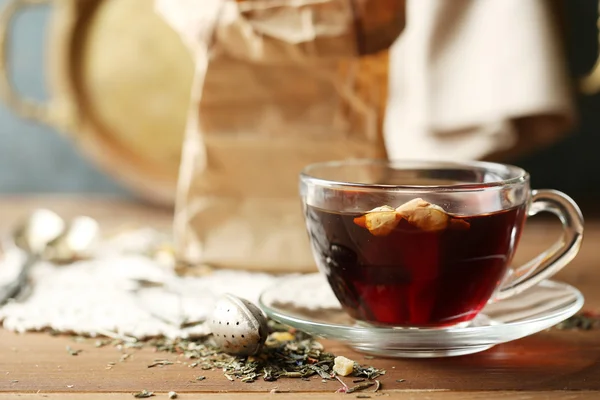 Beautiful vintage composition with herbal tea, on wooden table — Stock Photo, Image