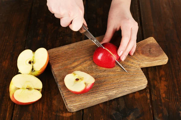 Mãos de mulher cortando maçãs — Fotografia de Stock