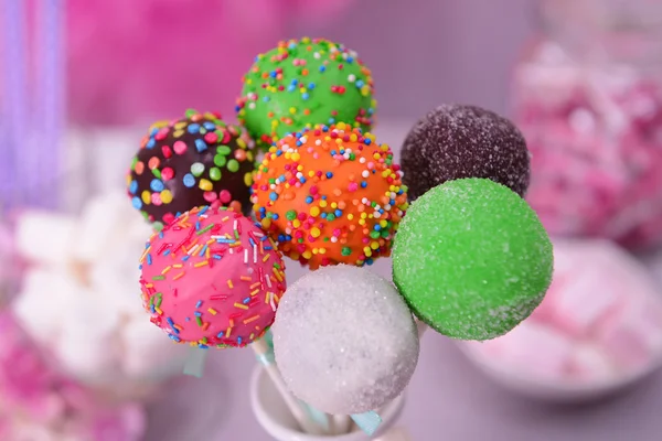 Sweet cake pops in vase on table on bright background — Stock Photo, Image