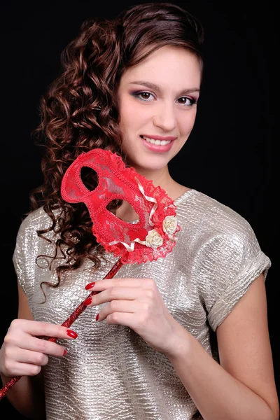 Beautiful girl with masquerade mask on dark background — Stock Photo, Image