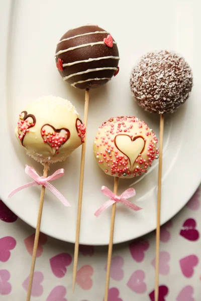 Tasty cake pops on plate, close up — Stock Photo, Image