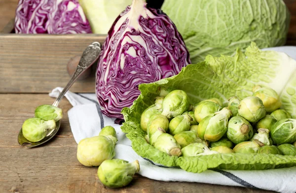 Still life with assortment cabbages on wooden background — Stock Photo, Image