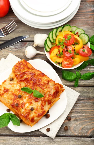 Portion of tasty lasagna on wooden table — Stock Photo, Image