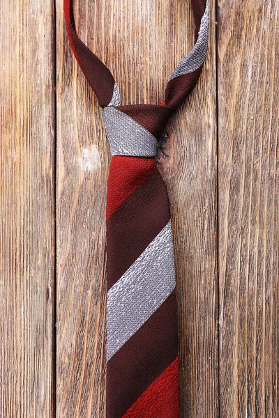 Stripped tie on wooden planks background — Stock Photo, Image