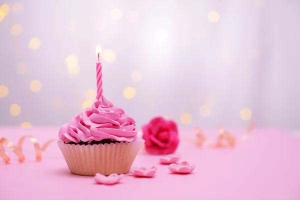 Delicious birthday cupcake on table on light background — Stock Photo, Image