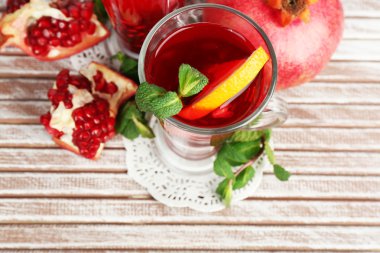 Nar İçecek gözlük nane ve turuncu renk ahşap plakalar arka plan üzerinde dilim ile