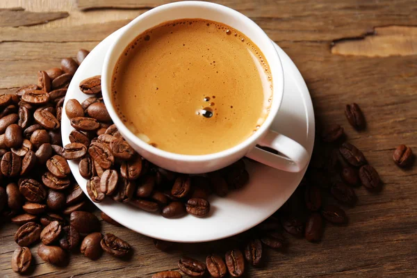 Cup of coffee on wooden table — Stock Photo, Image