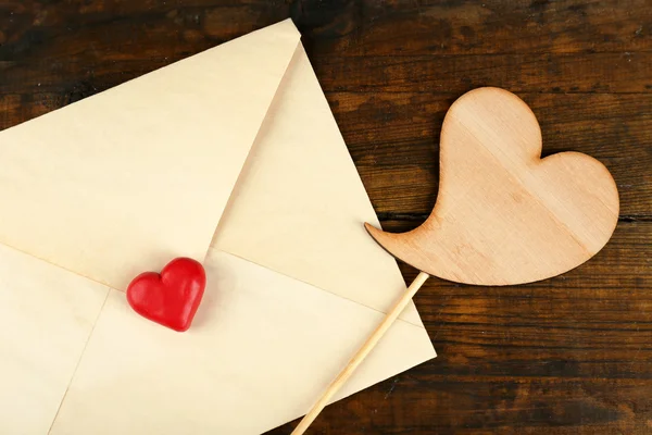 Envelope with hearts on table — Stock Photo, Image