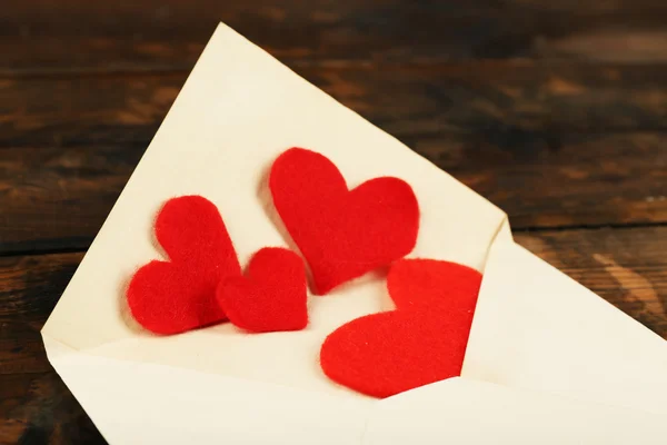 Envelope with hearts on table — Stock Photo, Image