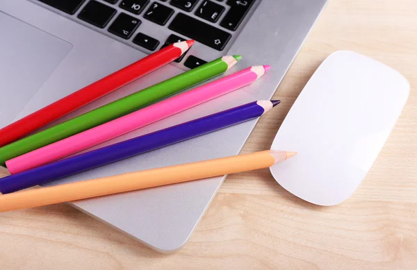 电脑鼠标和彩色铅笔木制表背景上的笔记本电脑 — 图库照片