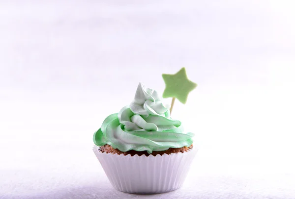 Delicious cupcake with inscription on table on beige background — Stock Photo, Image