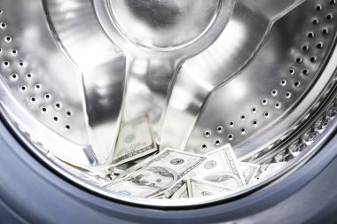 Money in washing machine, closeup view clipart