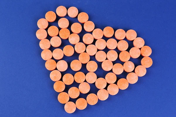 Heart of pills on blue background — Stock Photo, Image