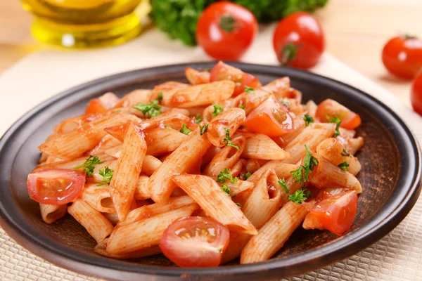 Pasta med tomatsås på tallriken på bordet närbild — Stockfoto