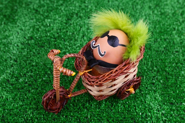 Egg riding bicycle on green background — Stock Photo, Image