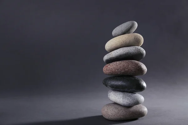 Pyramid of spa stones on dark background — Stock Photo, Image