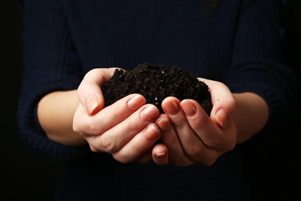 Handful of soil on dark background — Stock Photo, Image