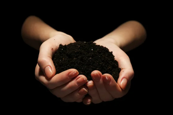 Handful of soil on dark background — Stock Photo, Image