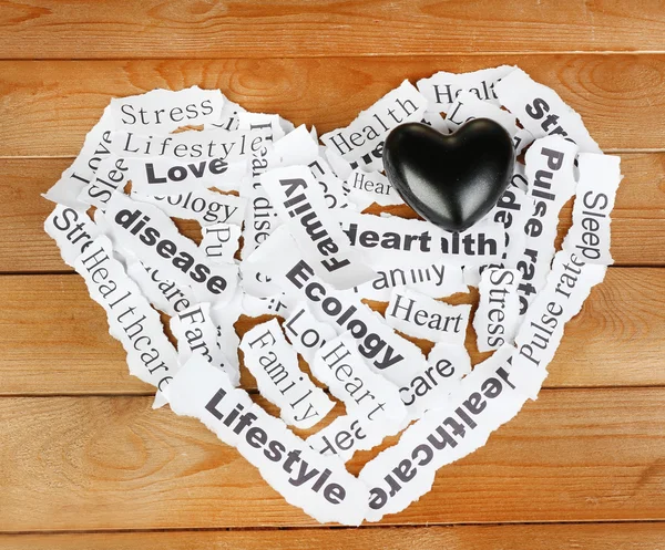 Decorative heart on paper notes, on wooden background — Stock Photo, Image