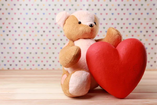 Teddy Bear with red heart on festive background — Stock Photo, Image