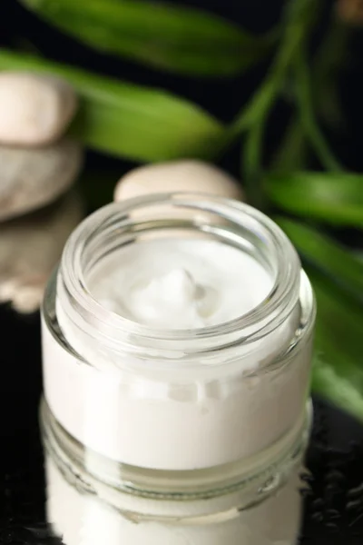 Face cream with bamboo on dark background — Stock Photo, Image