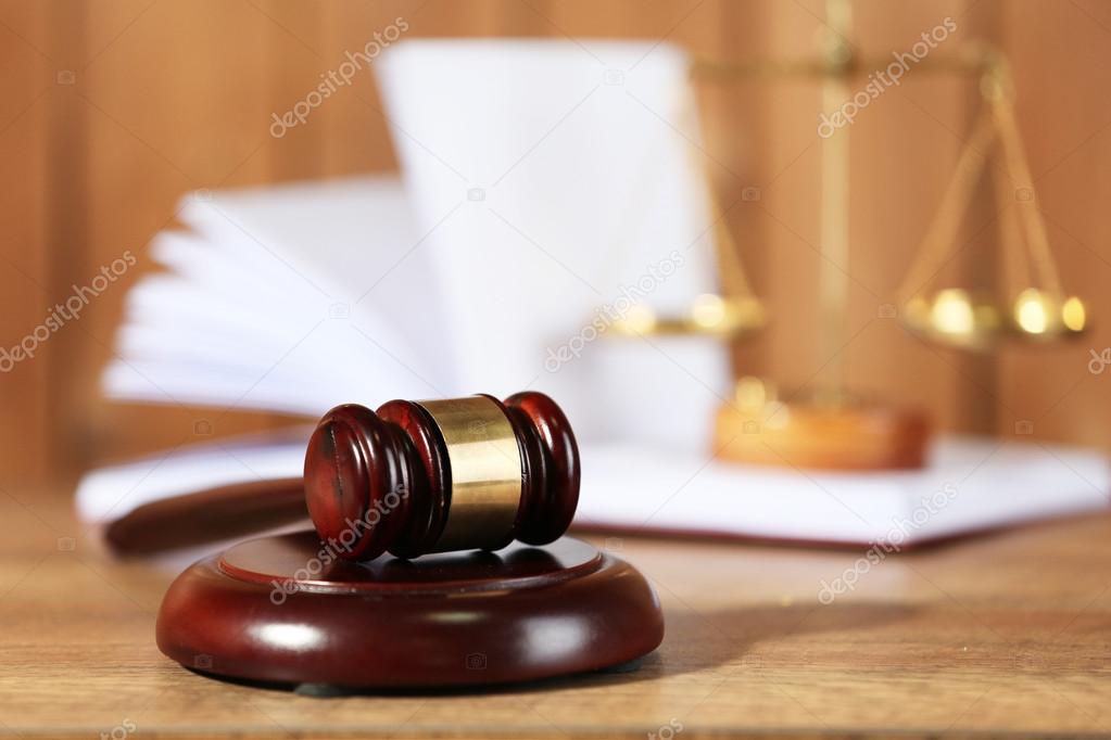 Wooden judges gavel on wooden table, close up