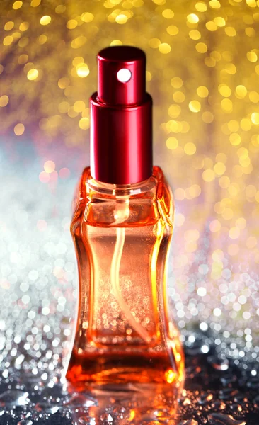 Women's perfume in beautiful bottle on festive shiny background — Stock Photo, Image