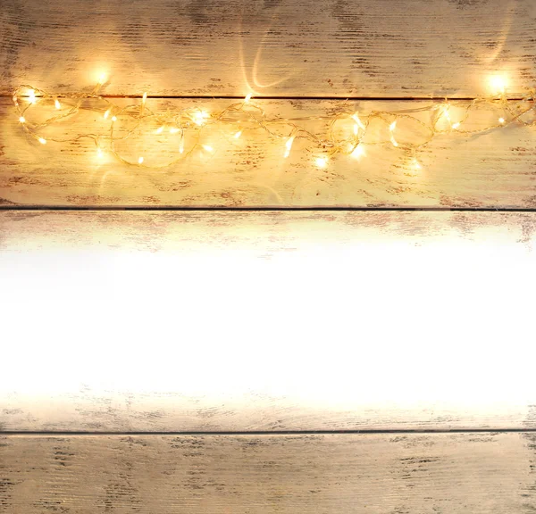 Luces navideñas sobre fondo de madera con espacio para tu texto — Foto de Stock