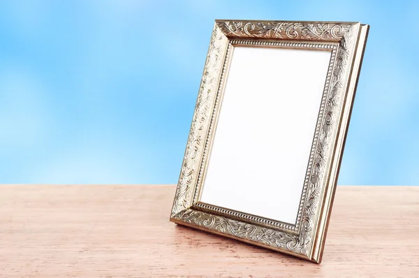 Photo frame on wooden table — Stock Photo, Image