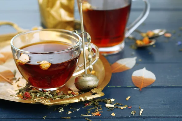 Beautiful vintage composition with herbal tea, on wooden table — Stock Photo, Image