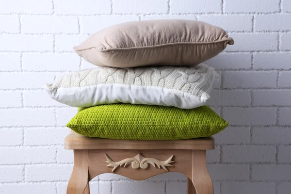 Pillows on small wooden table — Stock Photo, Image