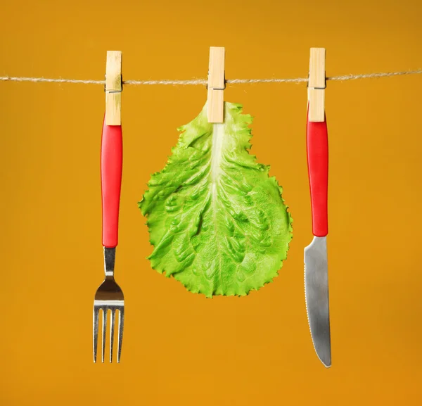 Fork, knife and salad leaf — Stock Photo, Image