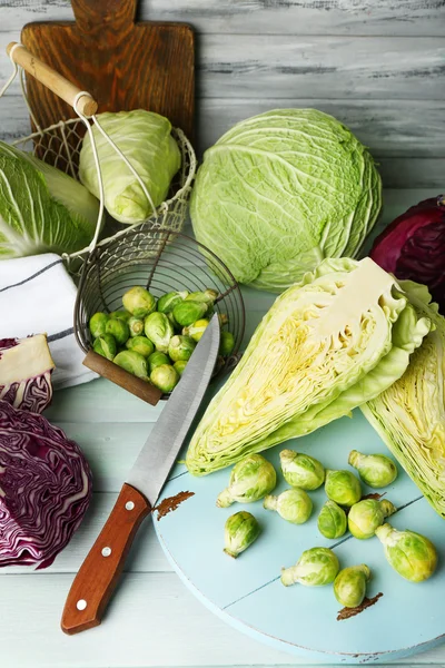 Still life with assortment cabbages on wooden background — Stock Photo, Image