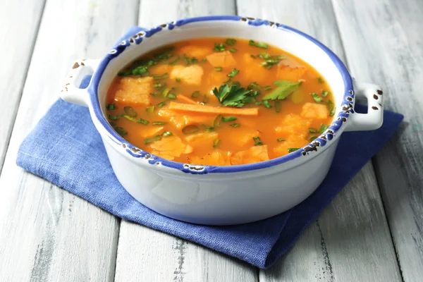 Carrot soup in bowl, on color wooden background — Stock Photo, Image