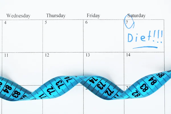 Measure tape on calendar — Stock Photo, Image