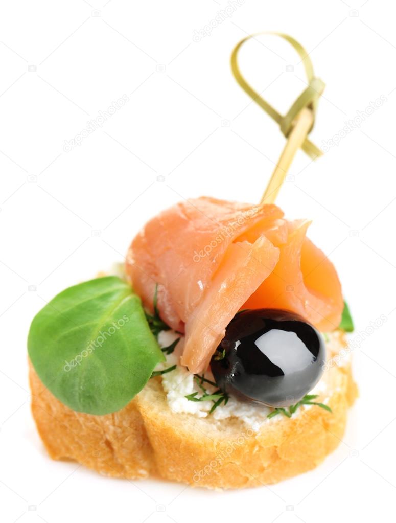 Canape with salmon, black olive and herbs isolated on white