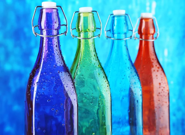 Colorful bottles on bright background — Stock Photo, Image